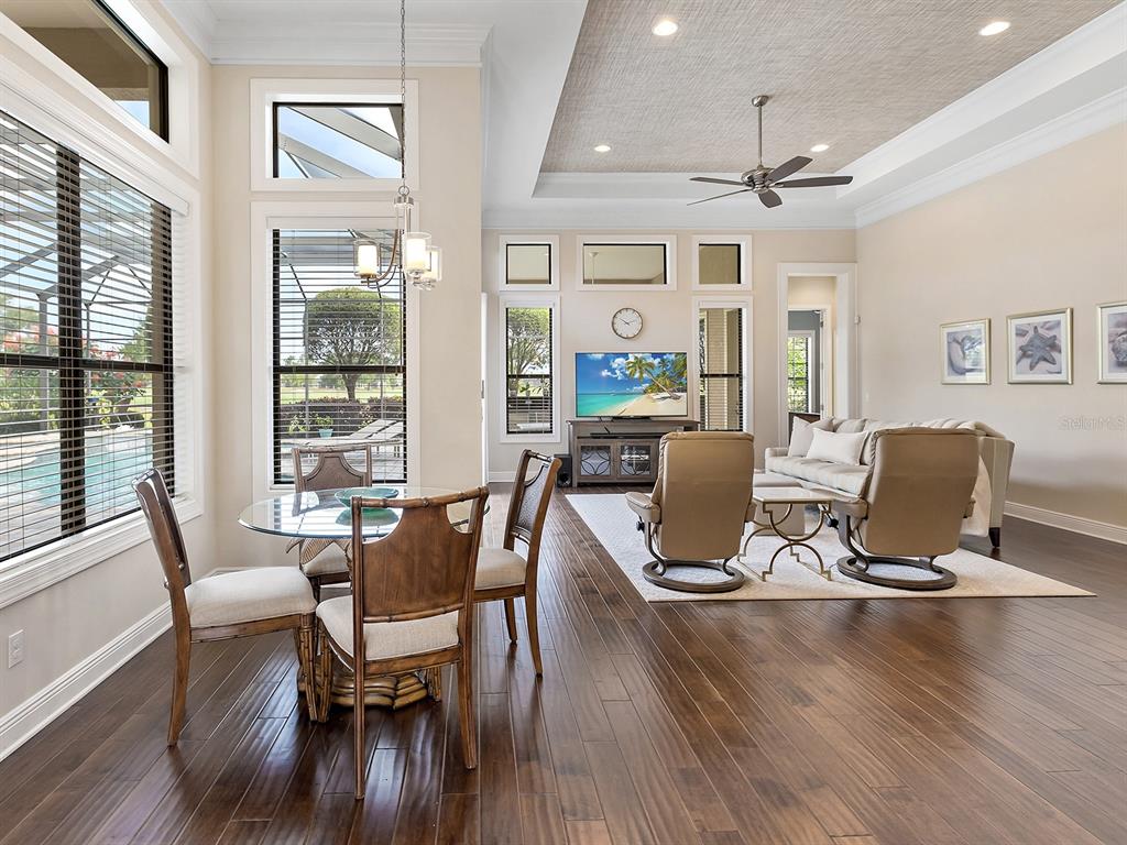 15207 Camargo Place Lakewood Ranch, FL 34202 - Photo 37 of 96 a view of a dining room with furniture window and wooden floor