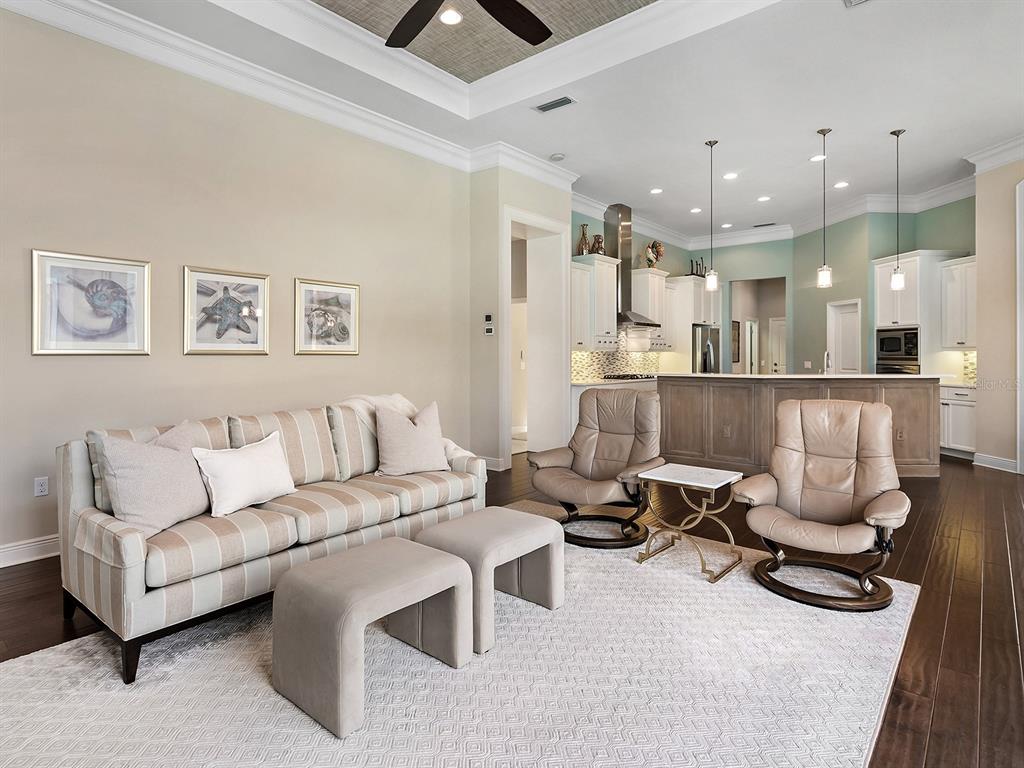 15207 Camargo Place Lakewood Ranch, FL 34202 - Photo 40 of 96 a living room with furniture and a wooden floor