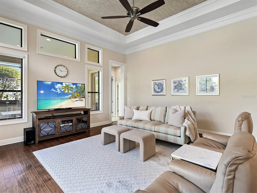 15207 Camargo Place Lakewood Ranch, FL 34202 - Photo 41 of 96 a living room with furniture a flat screen tv and a fireplace