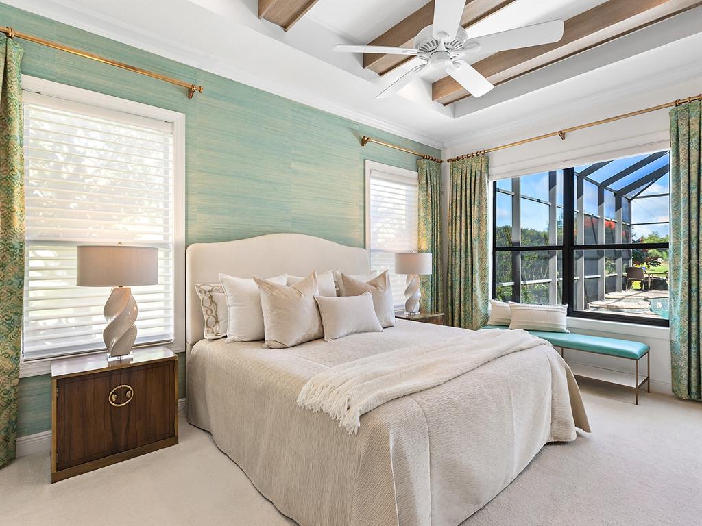 15207 Camargo Place Lakewood Ranch, FL 34202 - Photo 45 of 96 a bedroom with a large bed and a balcony