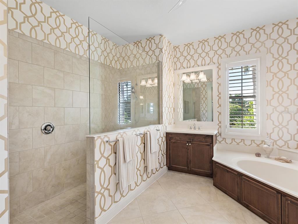 15207 Camargo Place Lakewood Ranch, FL 34202 - Photo 49 of 96 a spacious bathroom with a tub sink and mirror