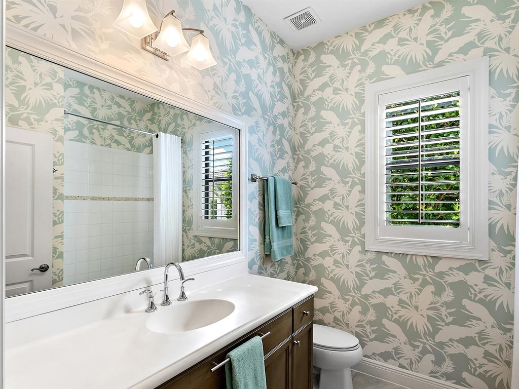 15207 Camargo Place Lakewood Ranch, FL 34202 - Photo 51 of 96 a bathroom with a sink a toilet and shower curtain