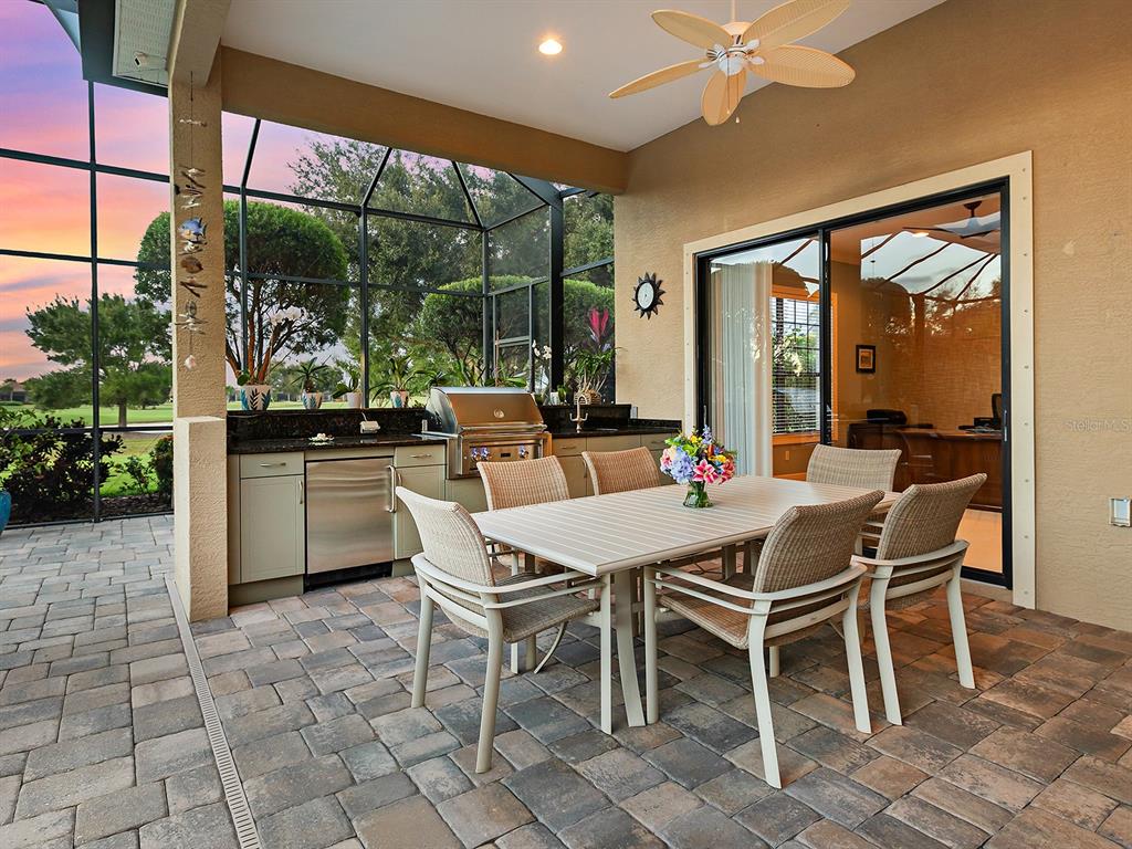 15207 Camargo Place Lakewood Ranch, FL 34202 - Photo 56 of 96 a dining room with furniture and a floor to ceiling window