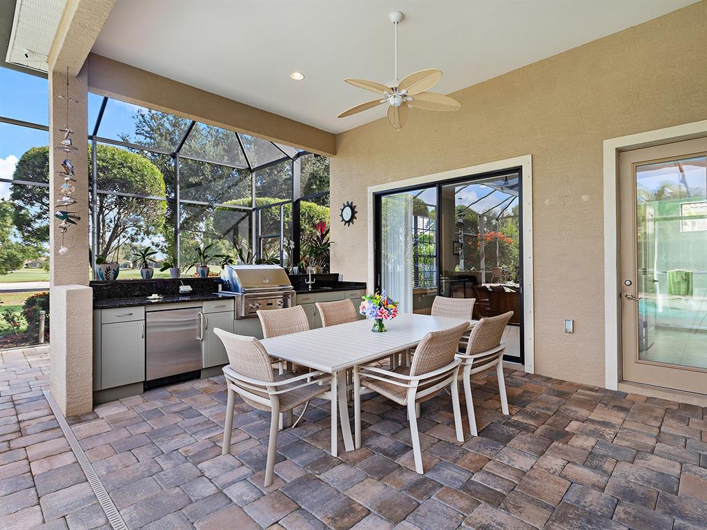 15207 Camargo Place Lakewood Ranch, FL 34202 - Photo 64 of 96 a dining room with furniture a chandelier and window