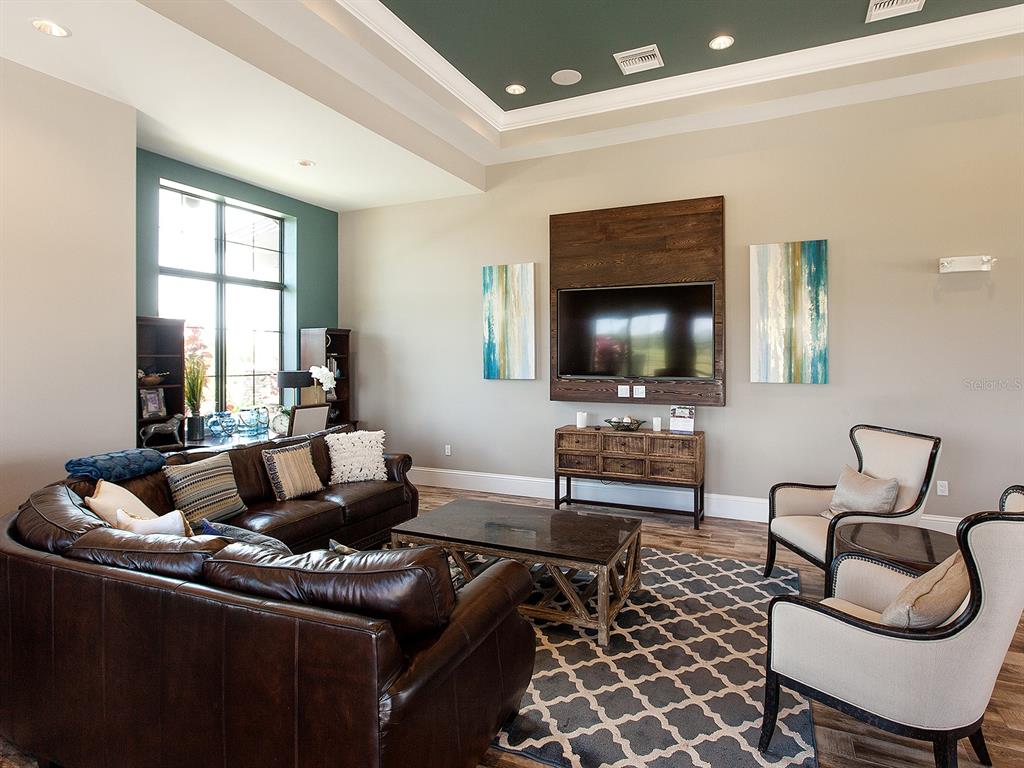 15207 Camargo Place Lakewood Ranch, FL 34202 - Photo 92 of 96 a living room with furniture and a flat screen tv
