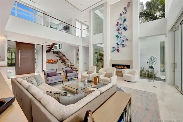 a view of a living room and bathroom with a bathtub