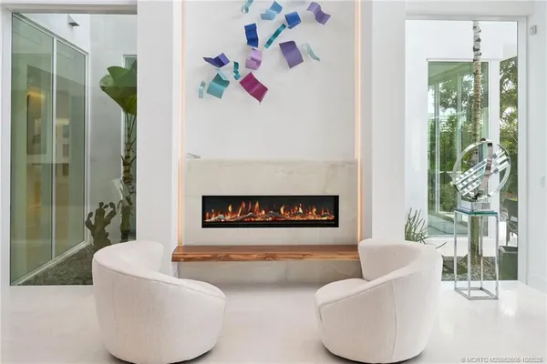 a dining room with large glass table and chairs