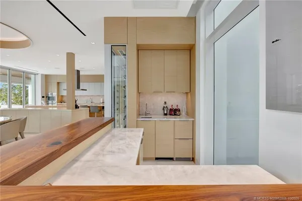 a large white kitchen with a large window