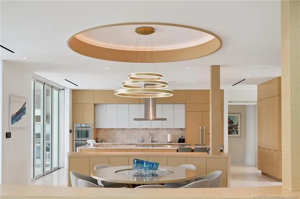 a kitchen with a white cabinets and refrigerator