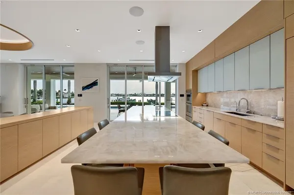 a spacious bedroom with a bed and glass walk in closet