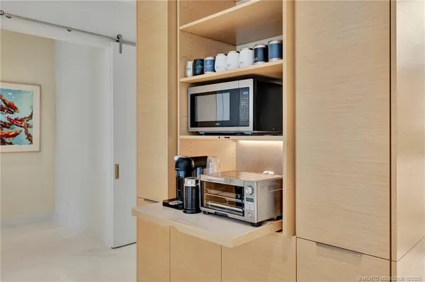 a living room with furniture and a baby crib