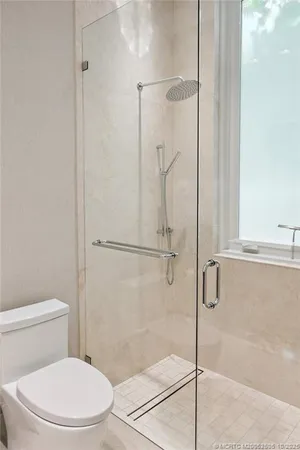 a bathroom with a glass shower door