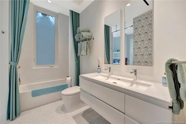 a bedroom with a bed and a large mirror