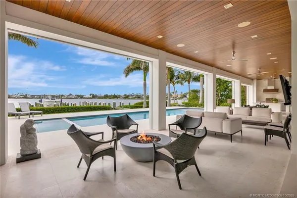 a dining room with furniture and a floor to ceiling window