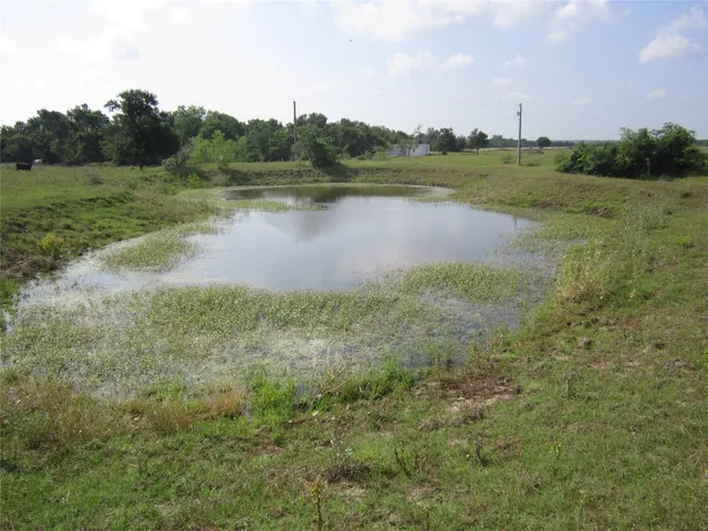 a view of a lake with houses in the back