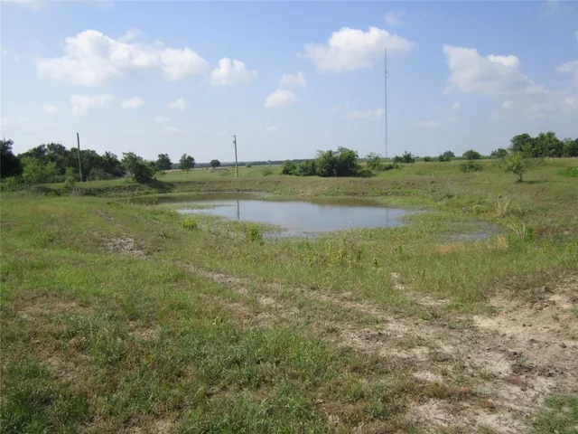 a view of a lake with houses in the back