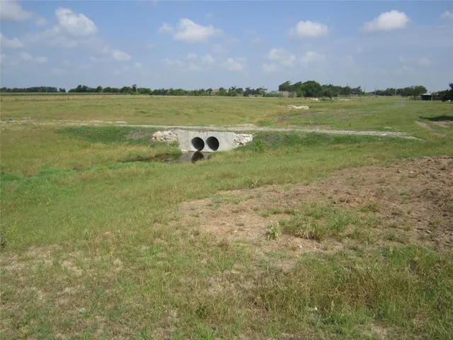 a view of a field with an ocean
