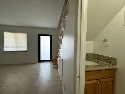 a view of a hallway to rooms and stairs