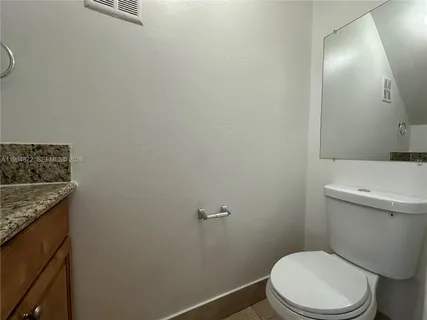 a white toilet sitting next to a bathroom sink