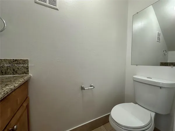 a white toilet sitting next to a bathroom sink