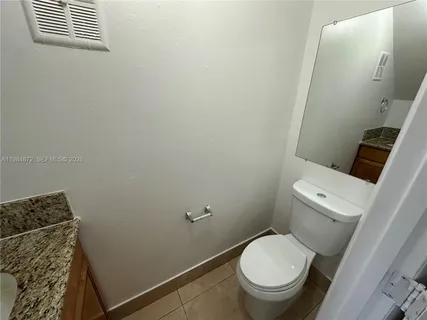a white toilet sitting next to a sink