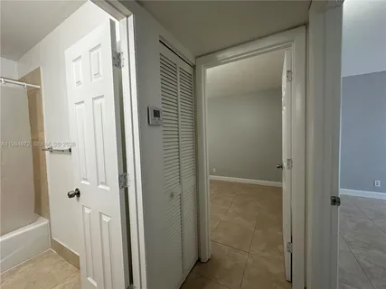 a bathroom with a shower and a glass door