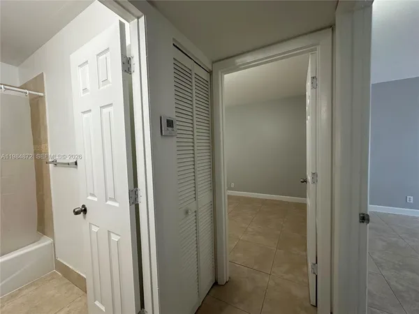 a bathroom with a shower and a glass door