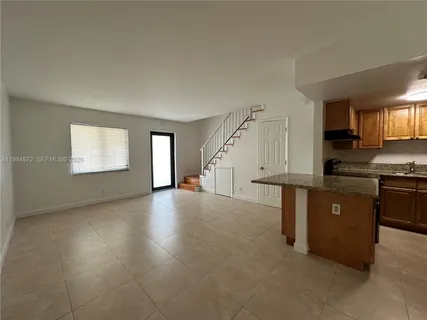 a view of kitchen with sink and cabinets
