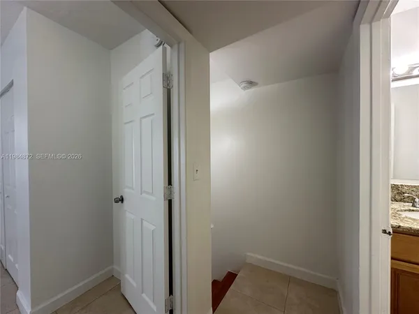 a bathroom with a granite countertop shower sink vanity mirror and toilet