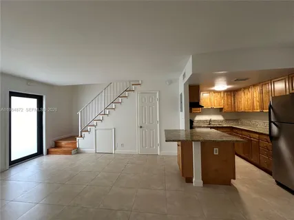 a kitchen with stainless steel appliances granite countertop a stove and a refrigerator