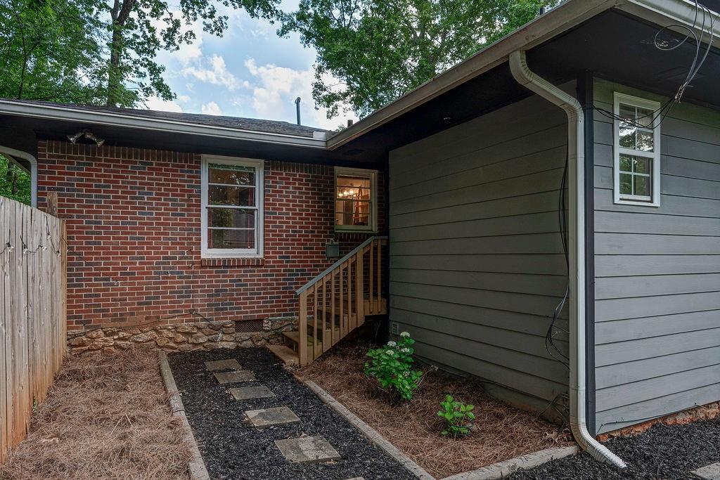 1140 Allgood Road Stone Mountain, GA 30083 - Photo 19 of 25 a side view of a house with a yard