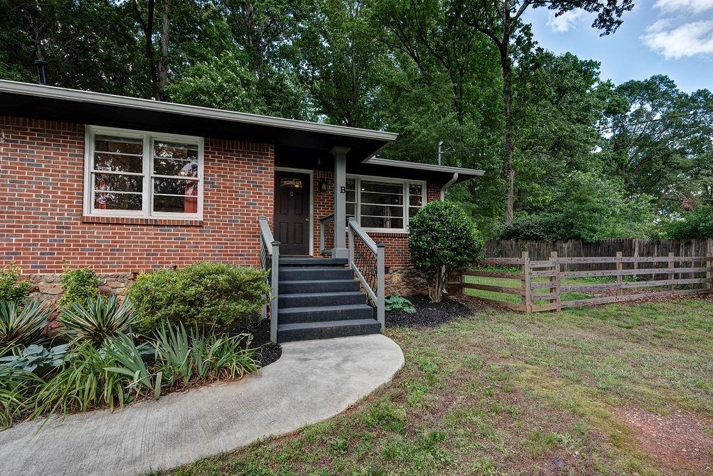 1140 Allgood Road Stone Mountain, GA 30083 - Photo 2 of 25 a view of a house with wooden fence next to a yard