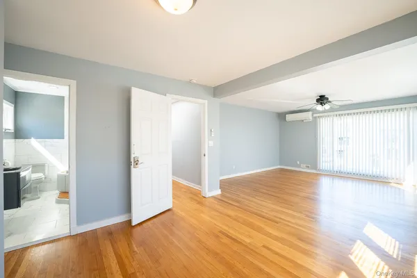 a view of empty room with wooden floor