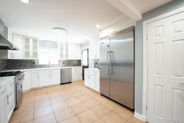 a large kitchen with a cabinets and a refrigerator