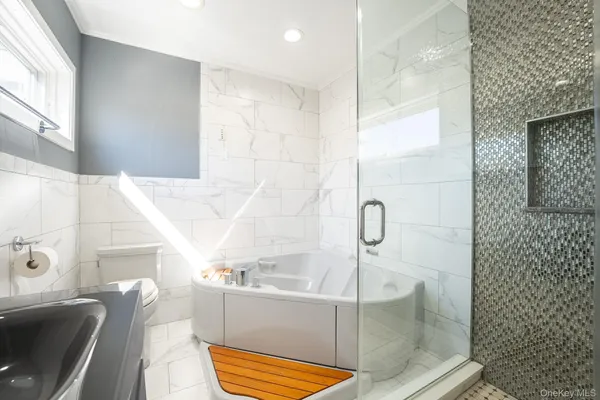 a bathroom with a tub and shower