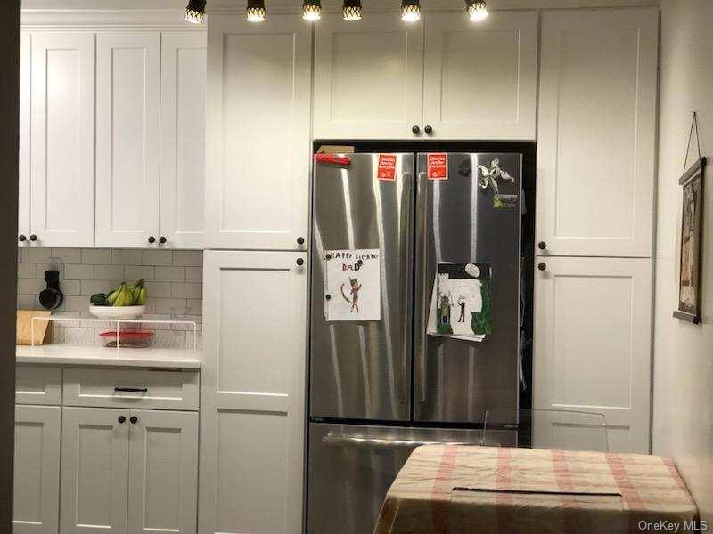 a refrigerator freezer sitting inside of a kitchen