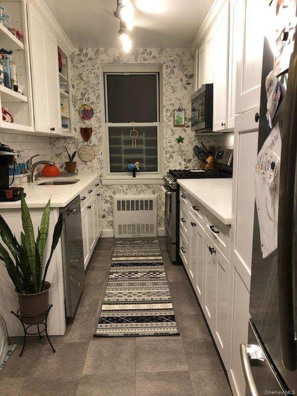 3176 Decatur Avenue, Unit 2H Bronx, NY 10467 - Photo 11 of 11 a kitchen with stainless steel appliances a sink stove and cabinets