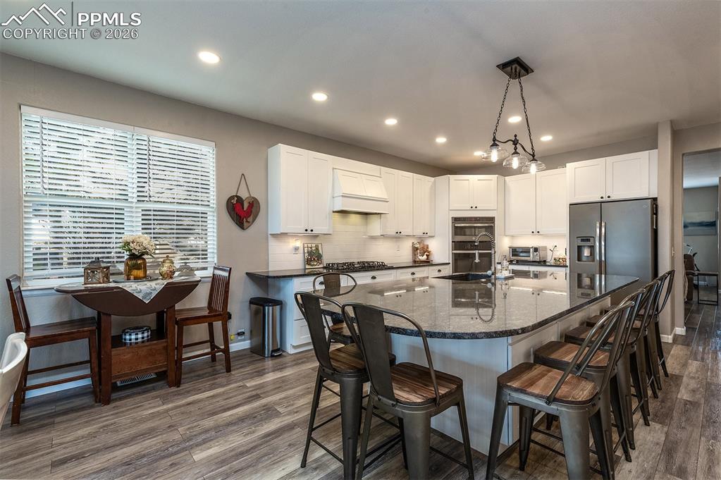 9066 Copenhagen Road Peyton, CO 80831 - Photo 12 of 34 a view of a dining room with furniture and wooden floor