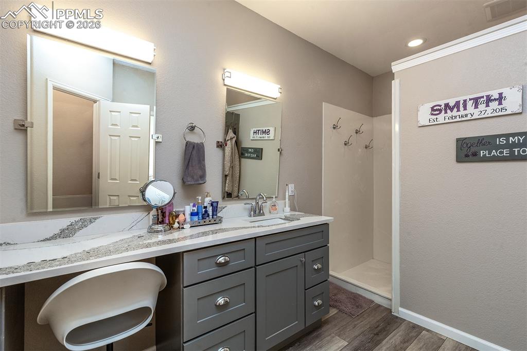 9066 Copenhagen Road Peyton, CO 80831 - Photo 15 of 34 a bathroom with a granite countertop double vanity sink and a mirror