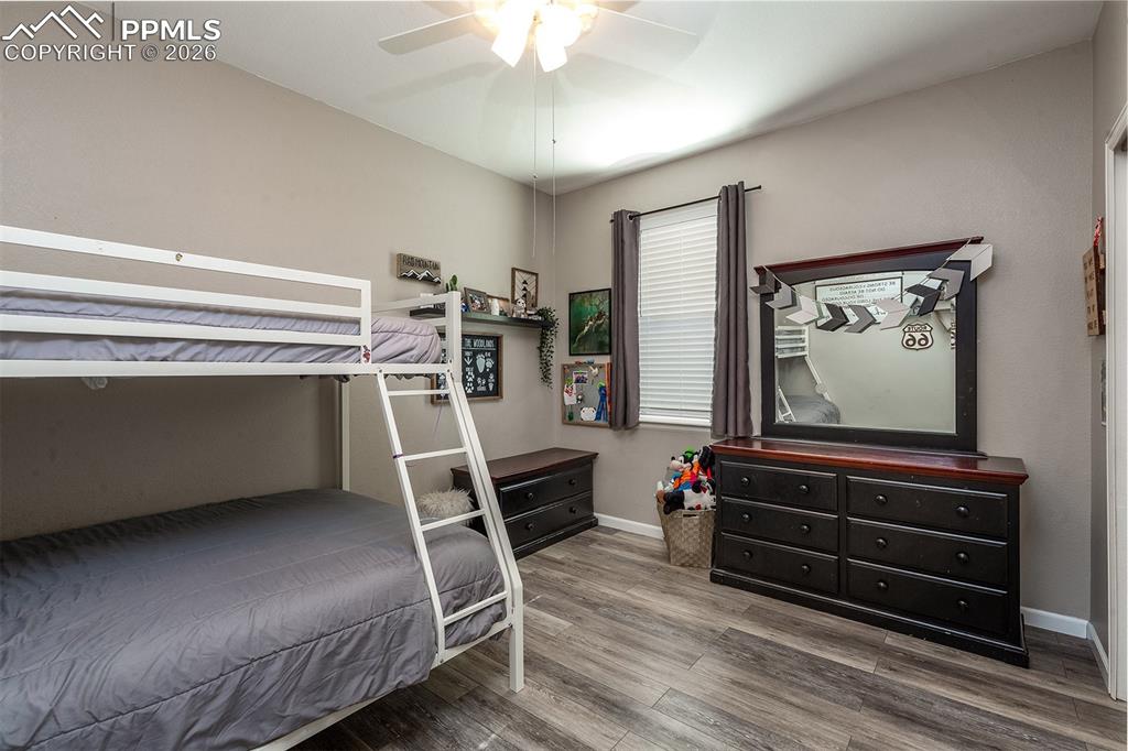 9066 Copenhagen Road Peyton, CO 80831 - Photo 19 of 34 a bedroom with furniture staircase and a rug