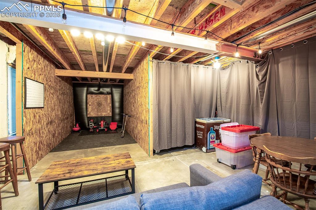9066 Copenhagen Road Peyton, CO 80831 - Photo 28 of 34 a living room with furniture and a chandelier
