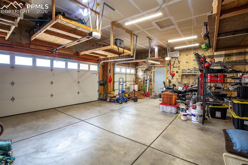 9066 Copenhagen Road Peyton, CO 80831 - Photo 30 of 34 a view of parking garage with cars