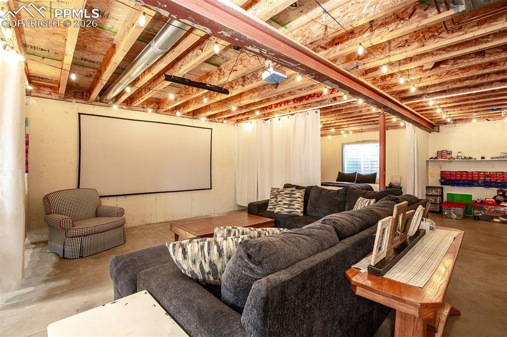 9066 Copenhagen Road Peyton, CO 80831 - Photo 32 of 34 a living room with furniture and a flat screen tv