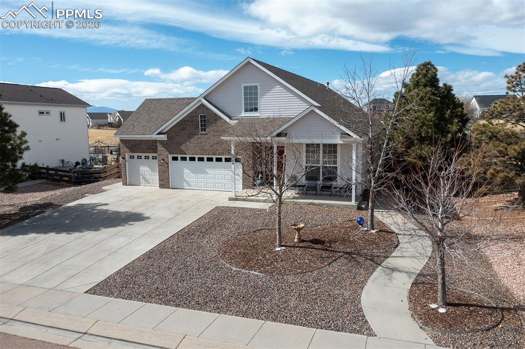 9066 Copenhagen Road Peyton, CO 80831 - Photo 4 of 34 a front view of a house with a yard and garage