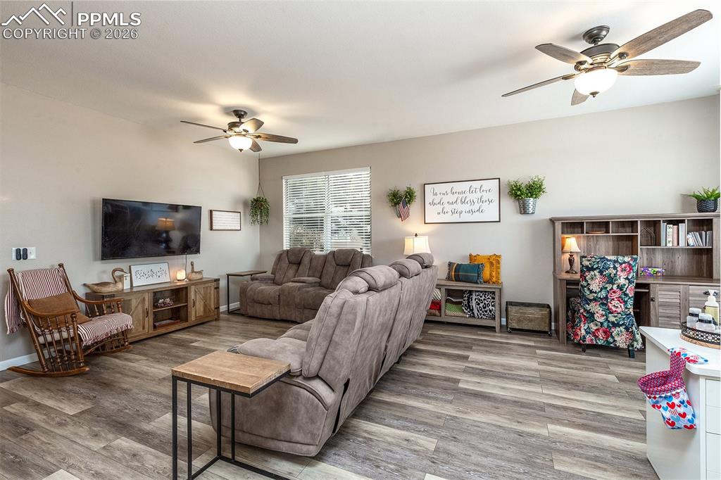 9066 Copenhagen Road Peyton, CO 80831 - Photo 7 of 34 a living room with furniture a flat screen tv and a window