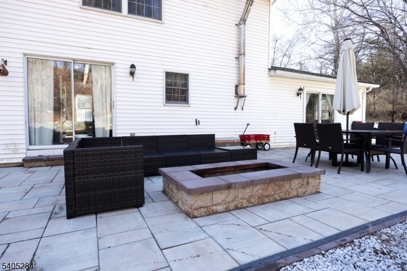 8 Luchetti Way Newton, NJ 07860 - Photo 19 of 20 a view of a patio with dining table and chairs