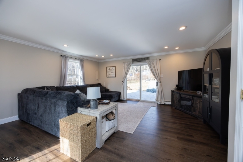 8 Luchetti Way Newton, NJ 07860 - Photo 5 of 20 a living room with furniture a flat screen tv and a refrigerator