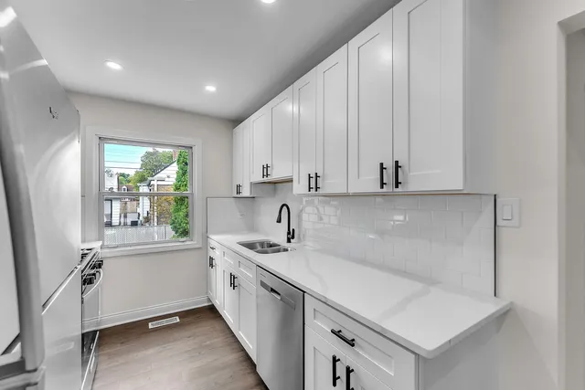 a kitchen with a sink a window and cabinets