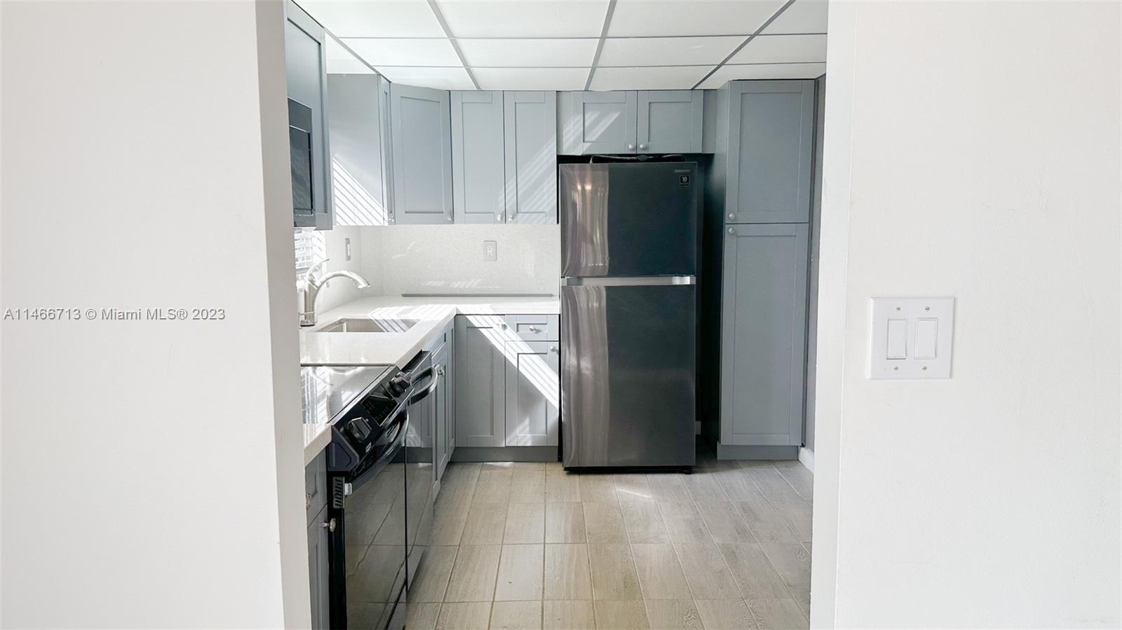 California Club Miami, FL 33179 - Photo 12 of 40 a kitchen with a refrigerator and a stove