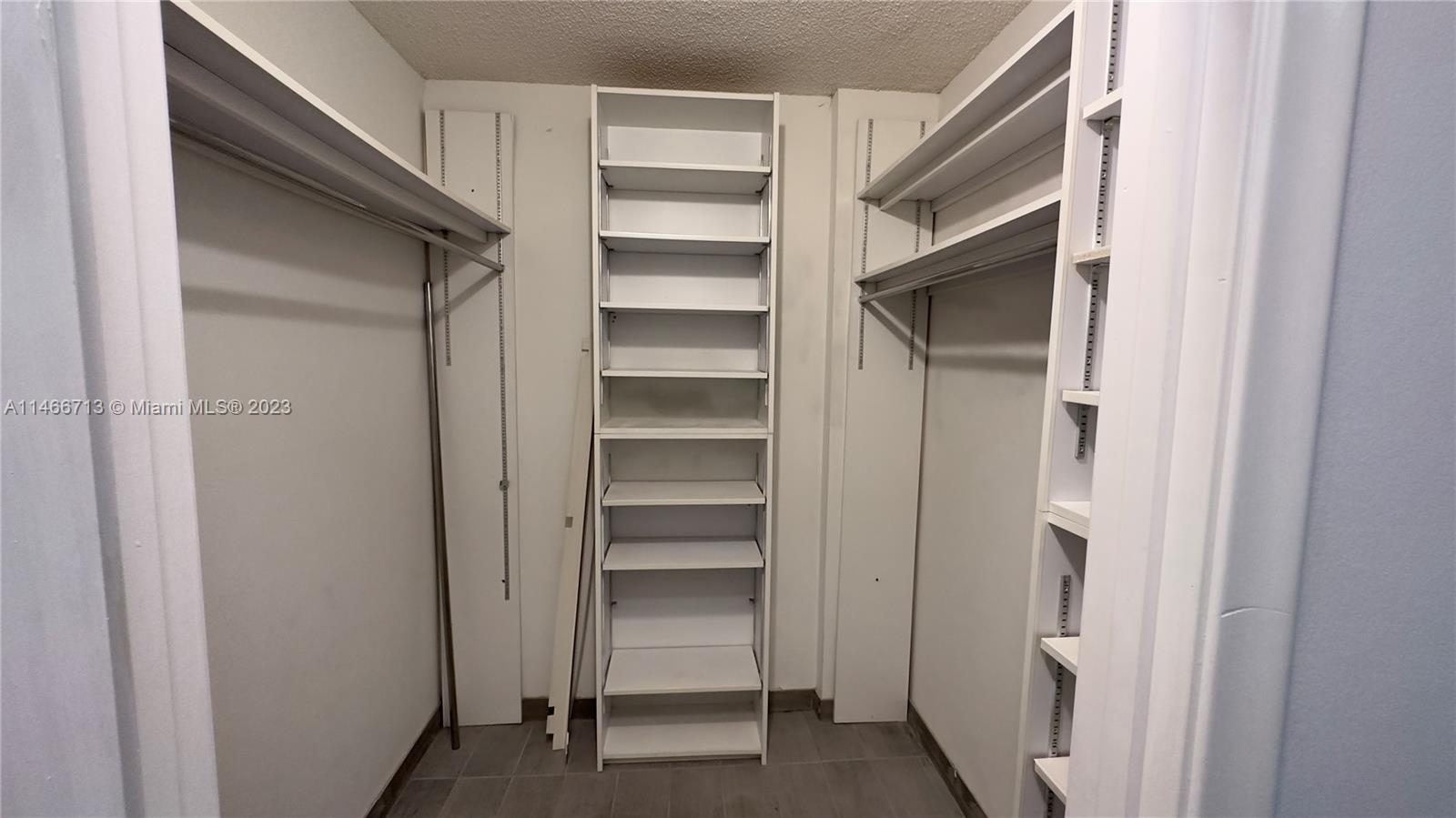 California Club Miami, FL 33179 - Photo 20 of 40 a view of walk in closet with empty racks